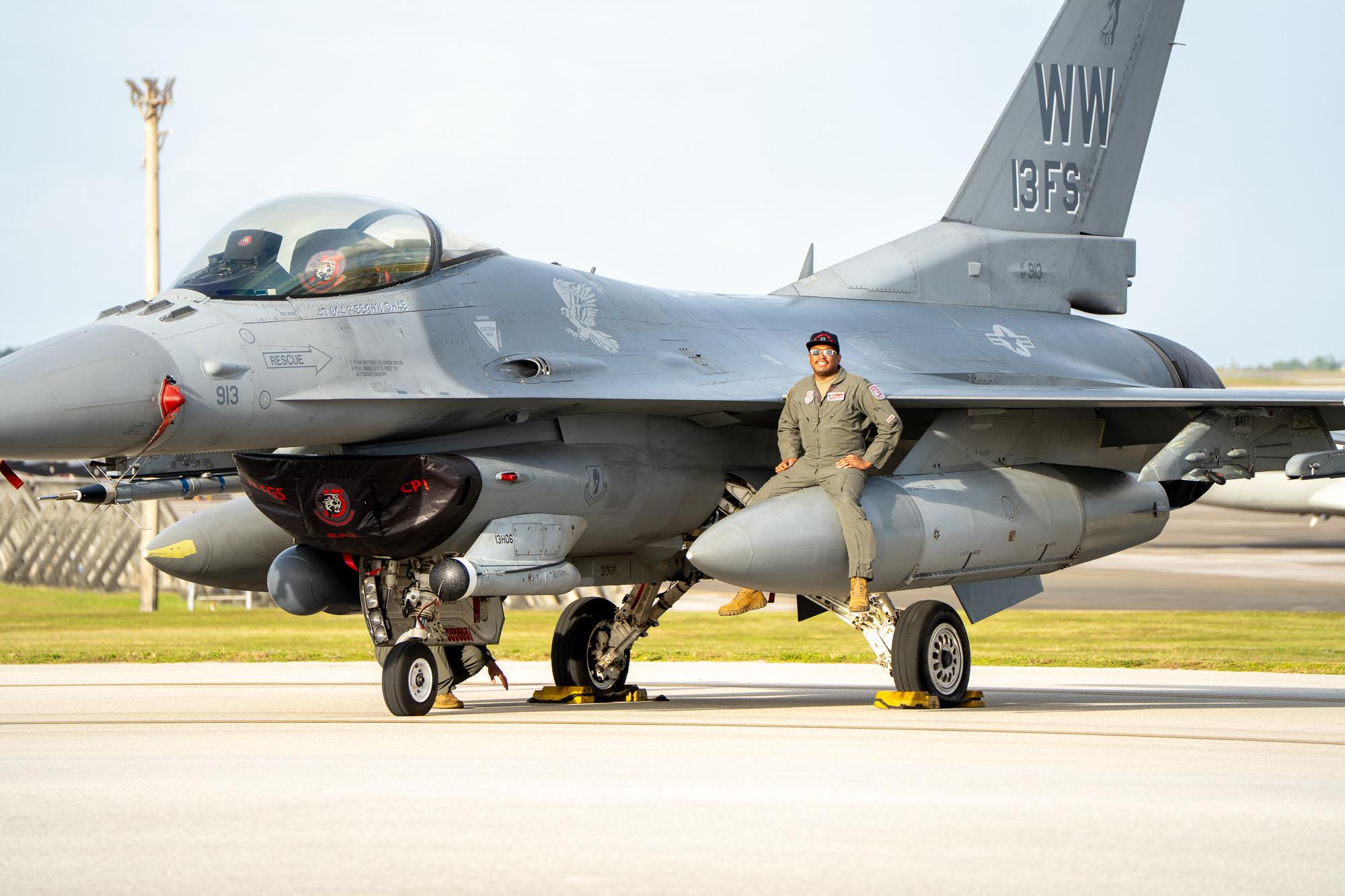 An airman with the USAF sits atop a 13th Fighter Squadron&#039;s F-16 Fighting Falcon&#039;s fuel pod. Photo by Skyler Obispo. 