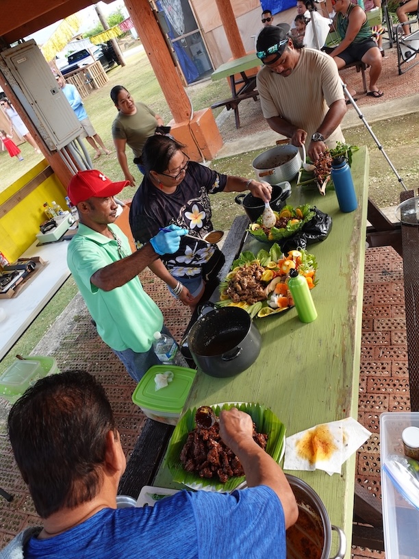Eventual 1st place winner Bill Cing, left, and other home cooks prepare their entries for the Estafao (spicy beef stew) Cooking Contest on Feb. 17, 2024, at the 20th Annual Tinian Hot Pepper Festival in The Marianas.