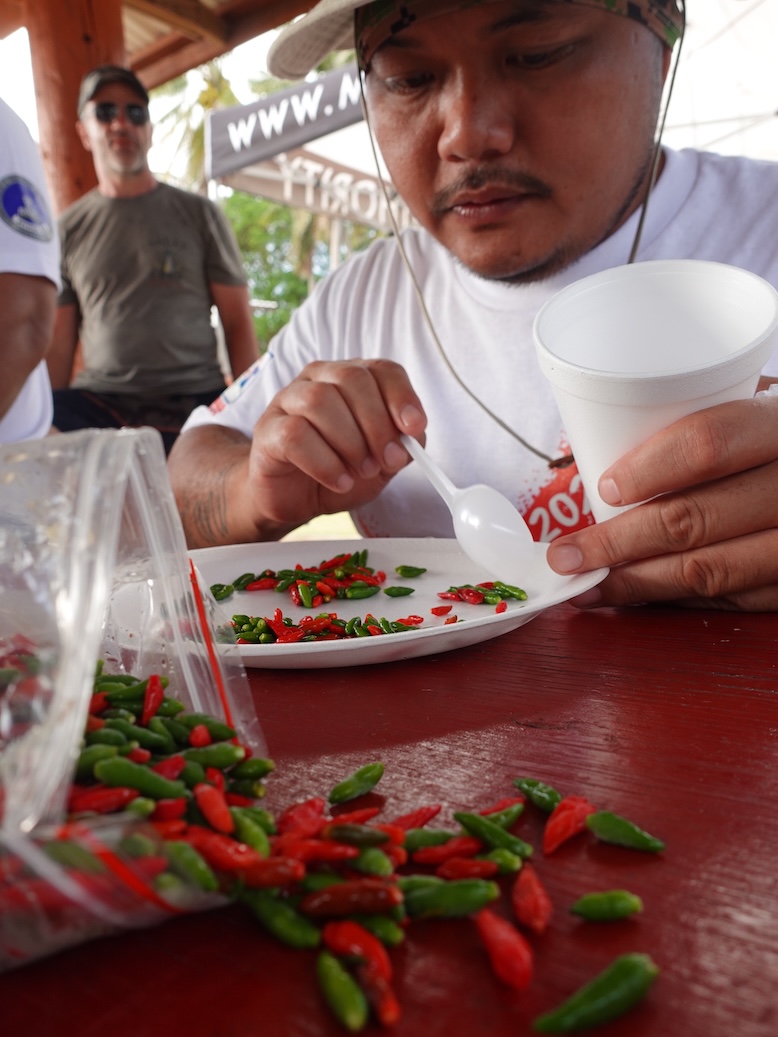 Brian Ayuyu of the Marianas Visitors Authority (MVA) carefully counts out 100 “donni Sali” hot pepper for the Triple J Hot Pepper Eating Contest.