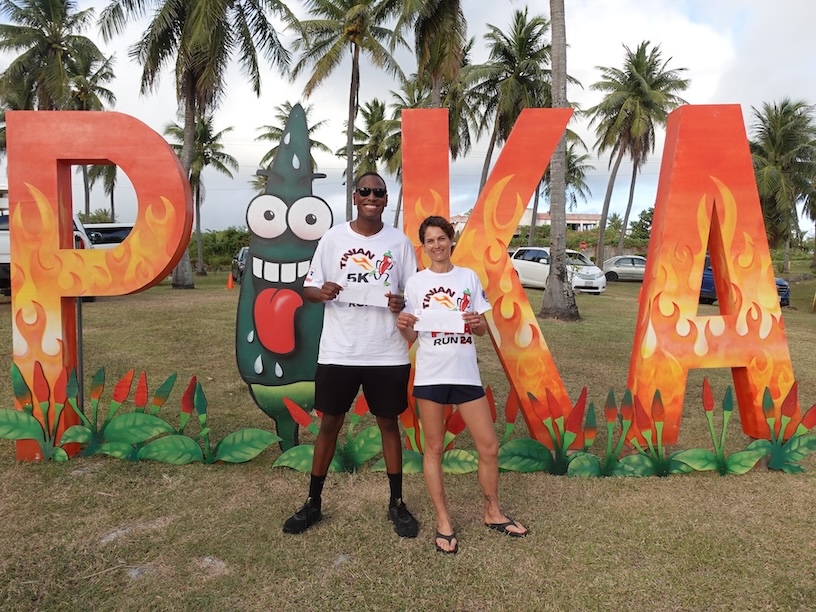 Men’s 2nd place finisher Jeff Pierrot, left, and Women’s 1st place finisher Virginie Ternisien accept their prize money for Top 3 finishes in the Pika Fun Run on Feb. 17, 2024, during the 20th Annual Tinian Hot Pepper Festival in The Marianas. Fifty-eight participants joined the inaugural race at the festival, organized by the Marianas Visitors Authority every President’s Day weekend in February.